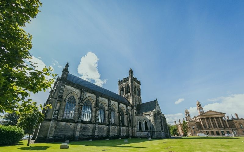 Paisley Abbey and the Town Hall under a blue sky